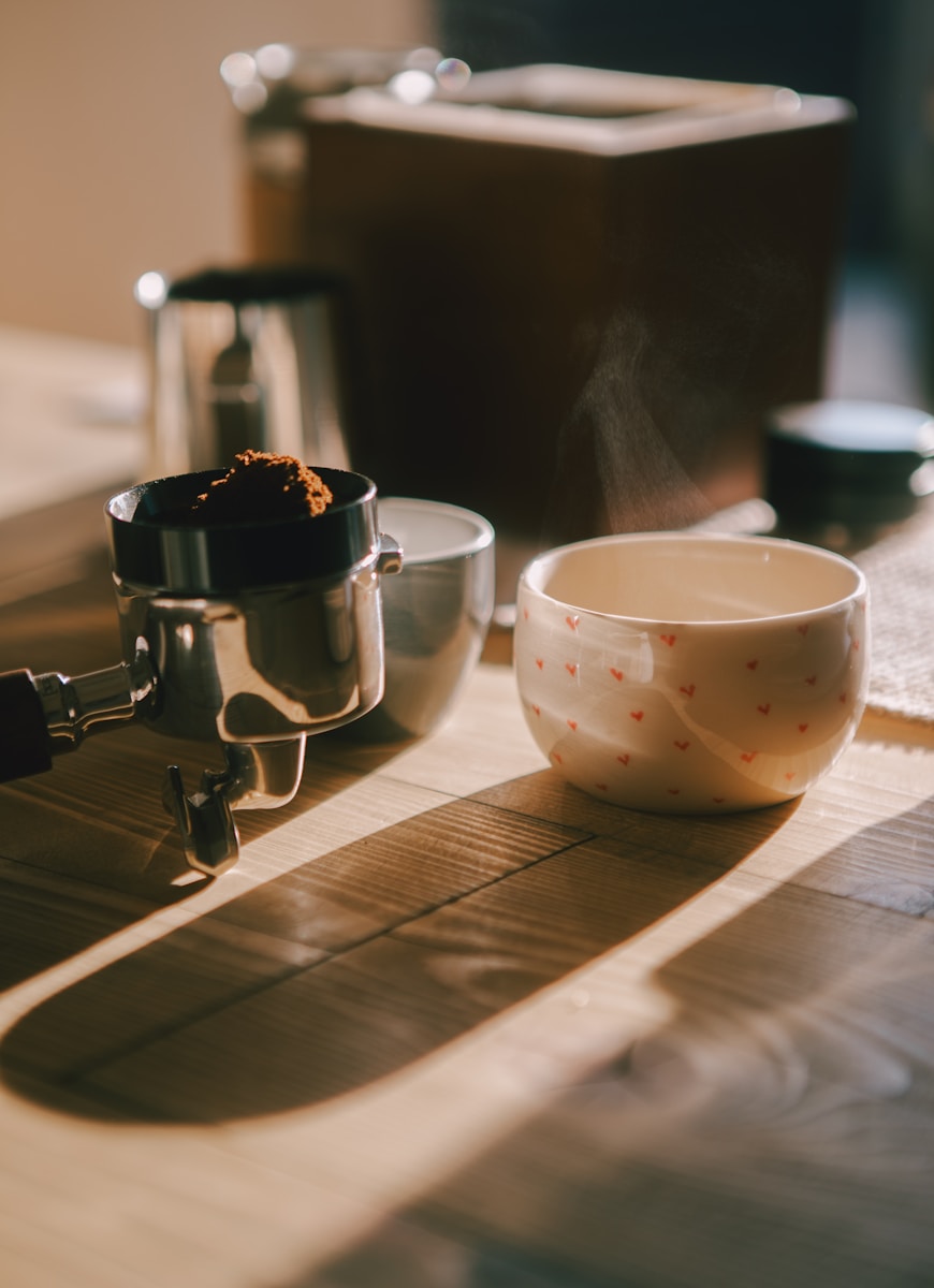 A cup of coffee sitting on top of a wooden table