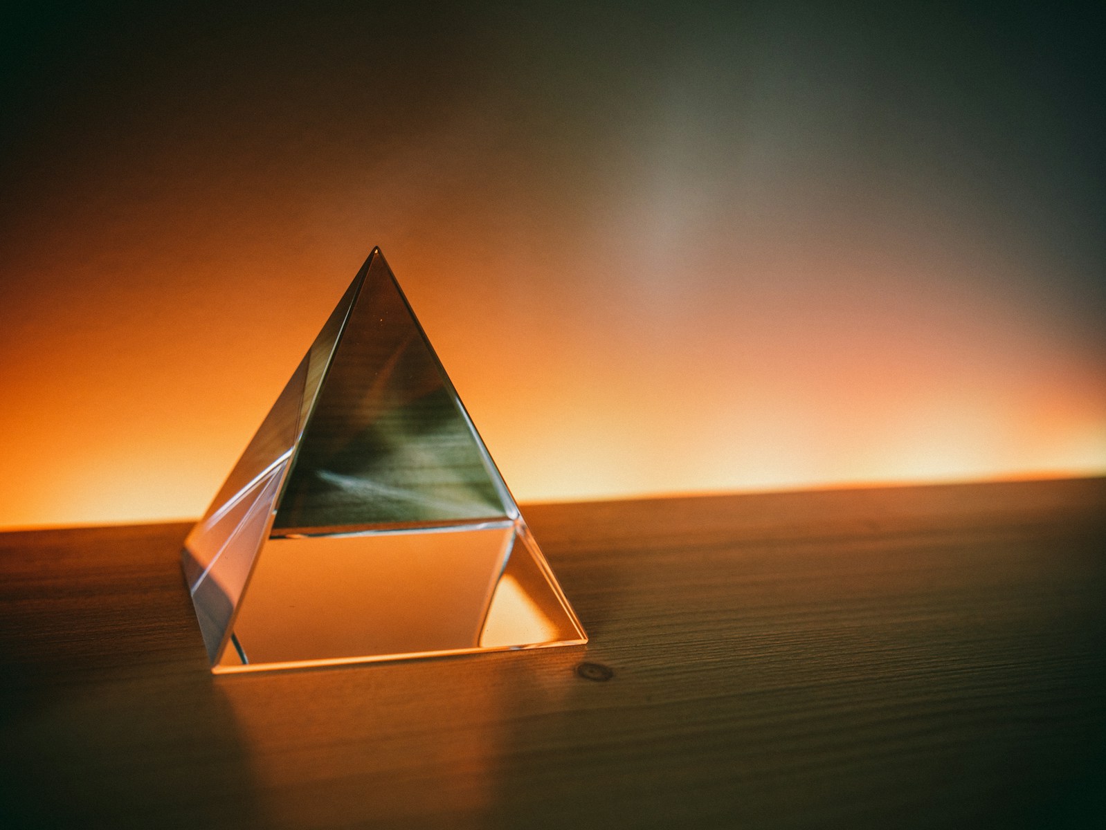 triangular brown and white wooden frame on brown sand during sunset