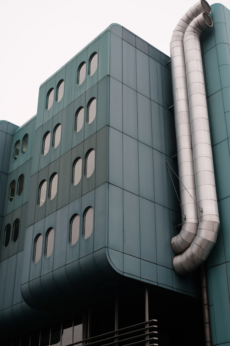 a large building with a large pipe on the side of it