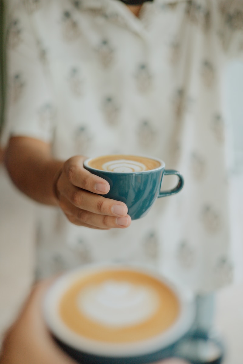 A person holding a cup of coffee in their hands