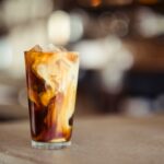 glass cup filled with ice latte on tabletop